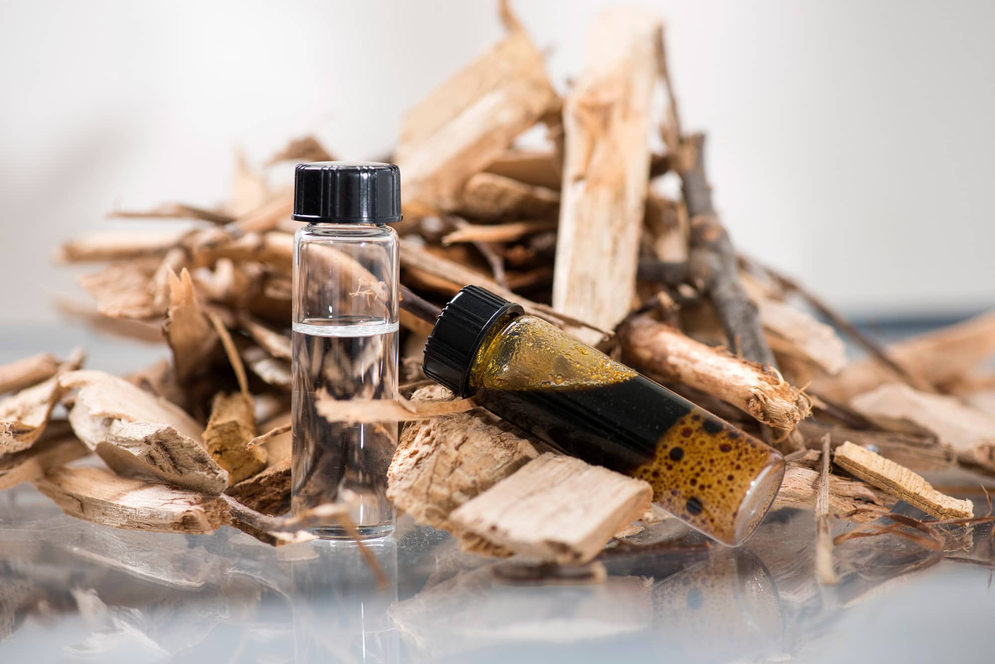 two vials of sustainable fuel and wood shavings