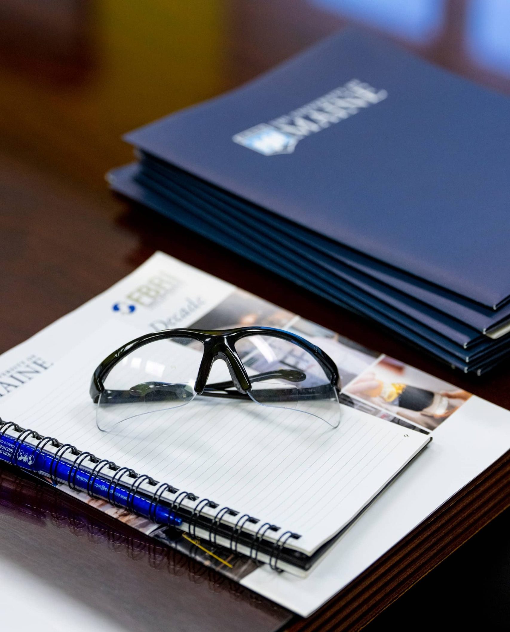 promotional materials on a table with safety glasses on top